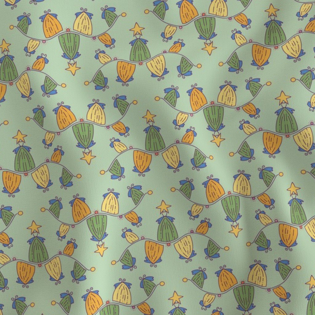 Fabric with waves of Christmas Trees in a line with wings in various colors of orange, yellow, green, all with stars on top in a repeat pattern.