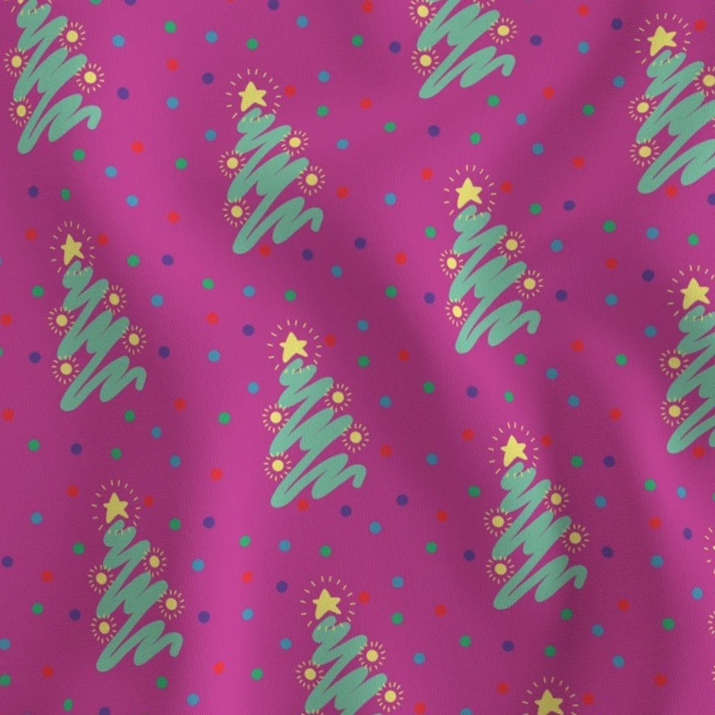 Fabric in a bright deep pink background with green scribbled Christmas trees with polkadots in colors of blue, light blue, purple, red repeat brick pattern