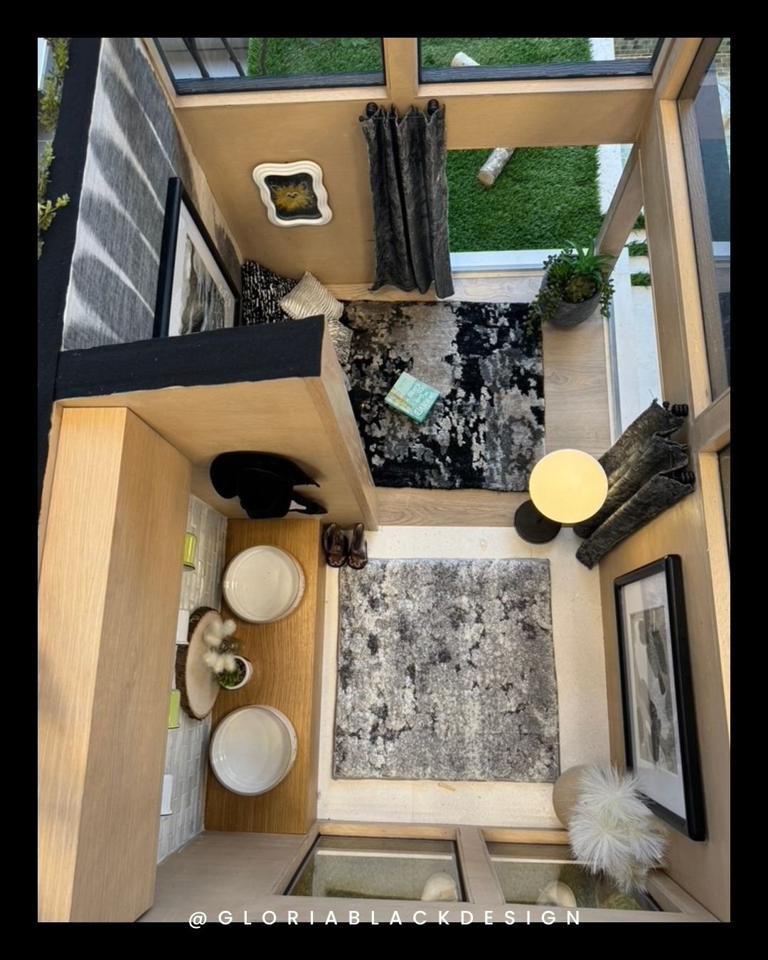 modern tiny house interior with wooden walls, large windows, decorative rugs, wall art, and tableware neatly arranged on a shelf. Bark and Build Ultimate Dog House Challenge by GLORIA BLACK DESIGN in Naples Florida. Great WOOF Lodge™ by GLORIA BLACK