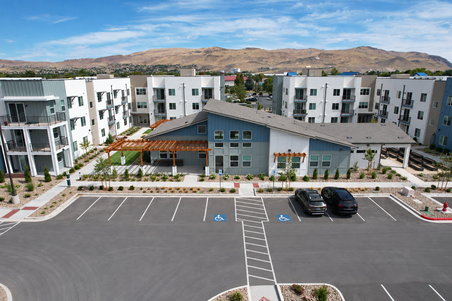 Modern Apartment Complex with Mountain Views.png