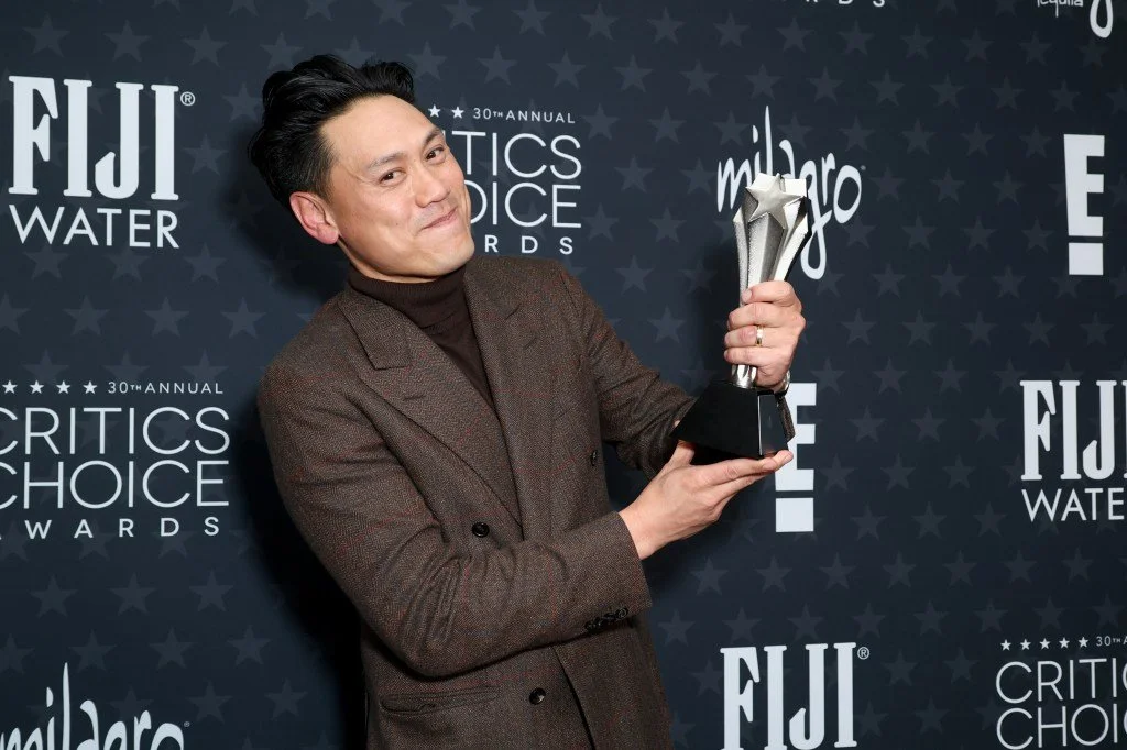 Jon M Chu holding award at Critics Choice Awards