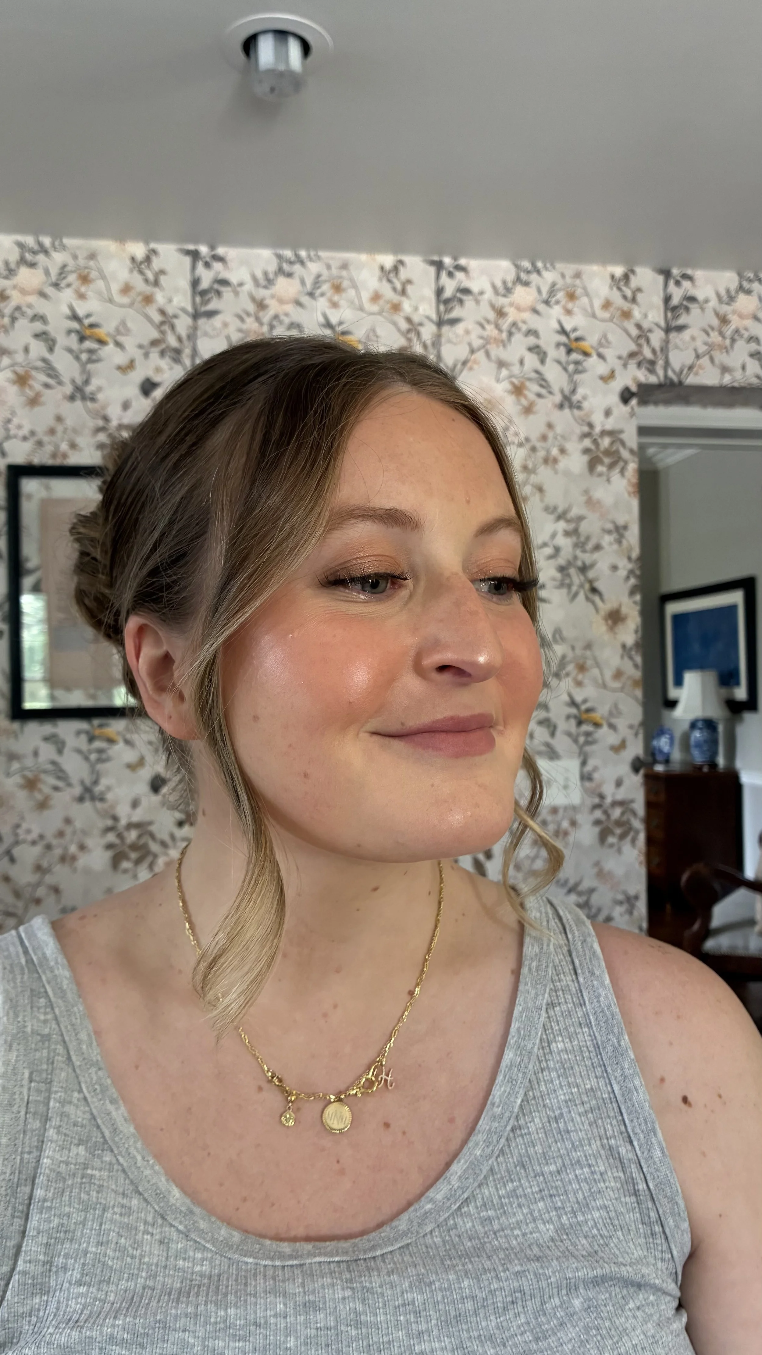 Side view of girl with an updo and full face of makeup.