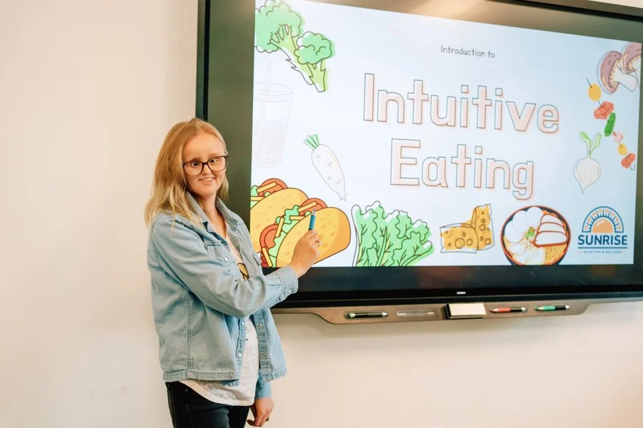 woman pointing to projected screen
