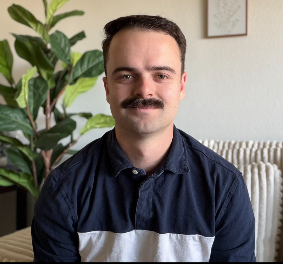 an image of Justin Packham smiling at the camera