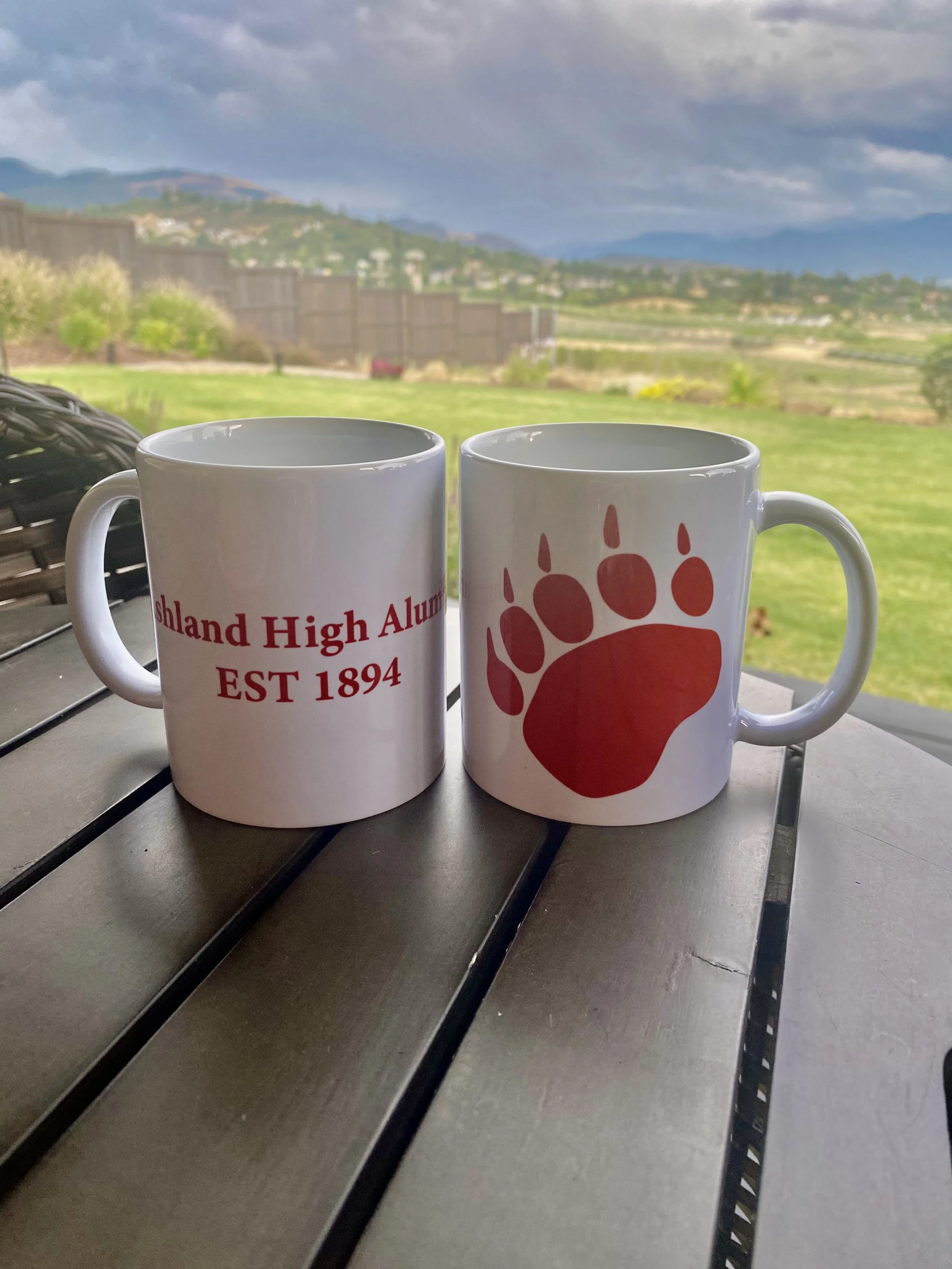 Illustration of a brown bear holding a coffee mug with a paw print, accompanied by the text "Alumni Coffee Hour."