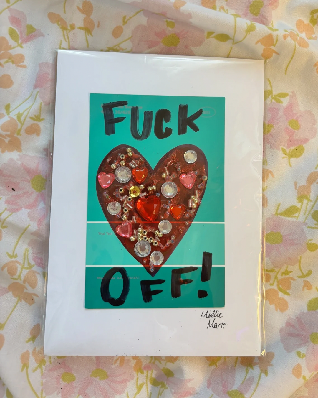 "Fuck Off!" /

March 2025 / 
Materials: Paint card, craft gems, beads, and Sharpie