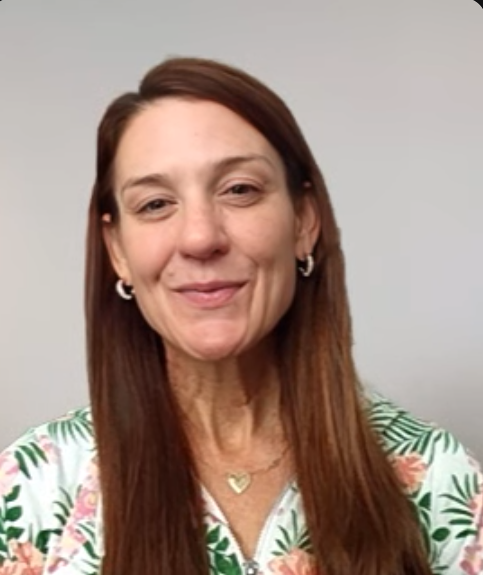 Dr. Sara Kyle, founder of LE3, smiling in a floral top against a plain background.