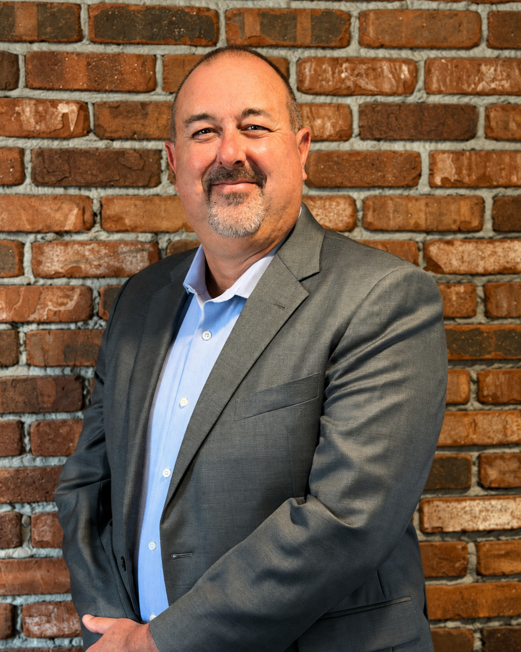 Leon Cavallo in front of a brick wall