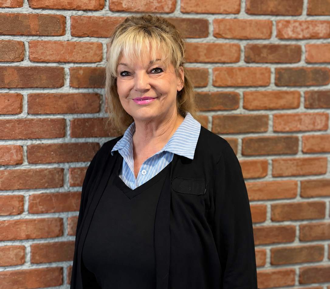 LORI MARSH in front of a brick wall