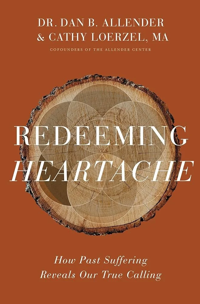 Book cover for 'Redeeming Heartache: How Past Suffering Reveals Our True Calling' by Dr. Dan B. Allender and Cathy Loerzel, featuring a cross-section of a tree trunk with intersecting circles on a brown background.