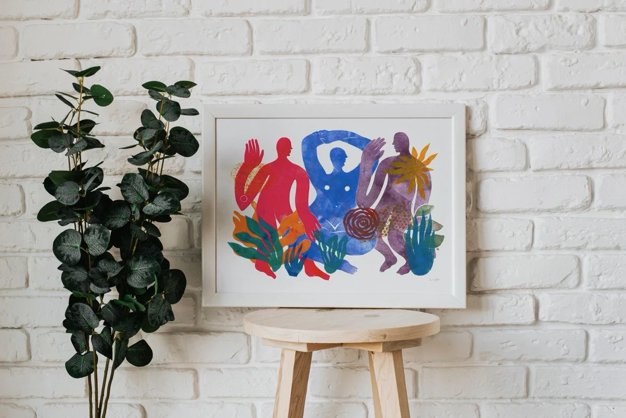 Rose Jaffe's print with red, blue, and purple figures displayed in a white frame with greenery to the left.