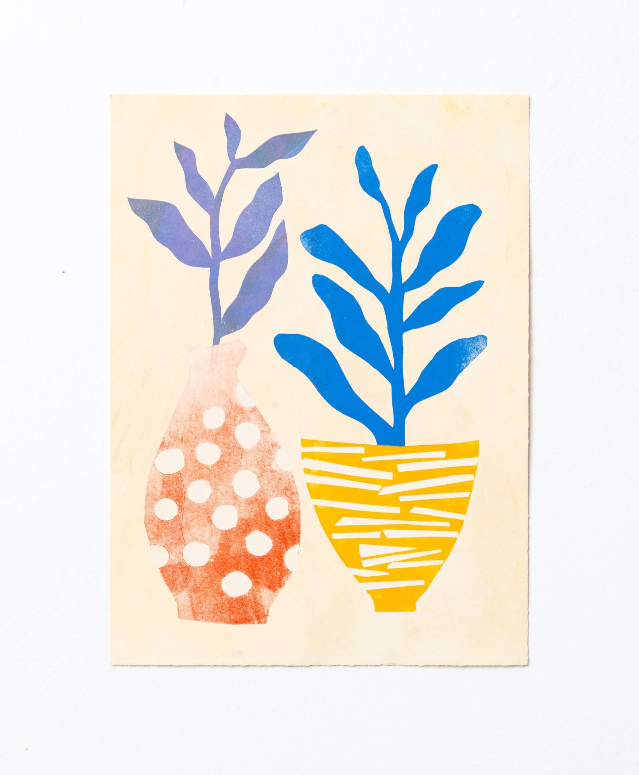 Two plants in patterned vases, one with polka dots and one with stripes. Artwork is of an original monoprint
