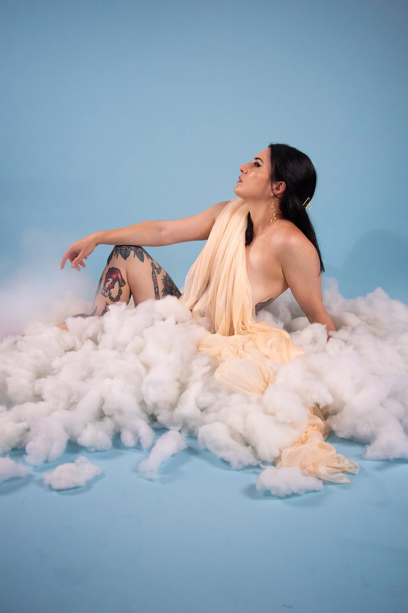Goddess in the clouds, Melbourne Dominatrix Doina Lucy Fleur in a studio shoot featuring clouds, smoke machine and draped fabric for a nude illusion 