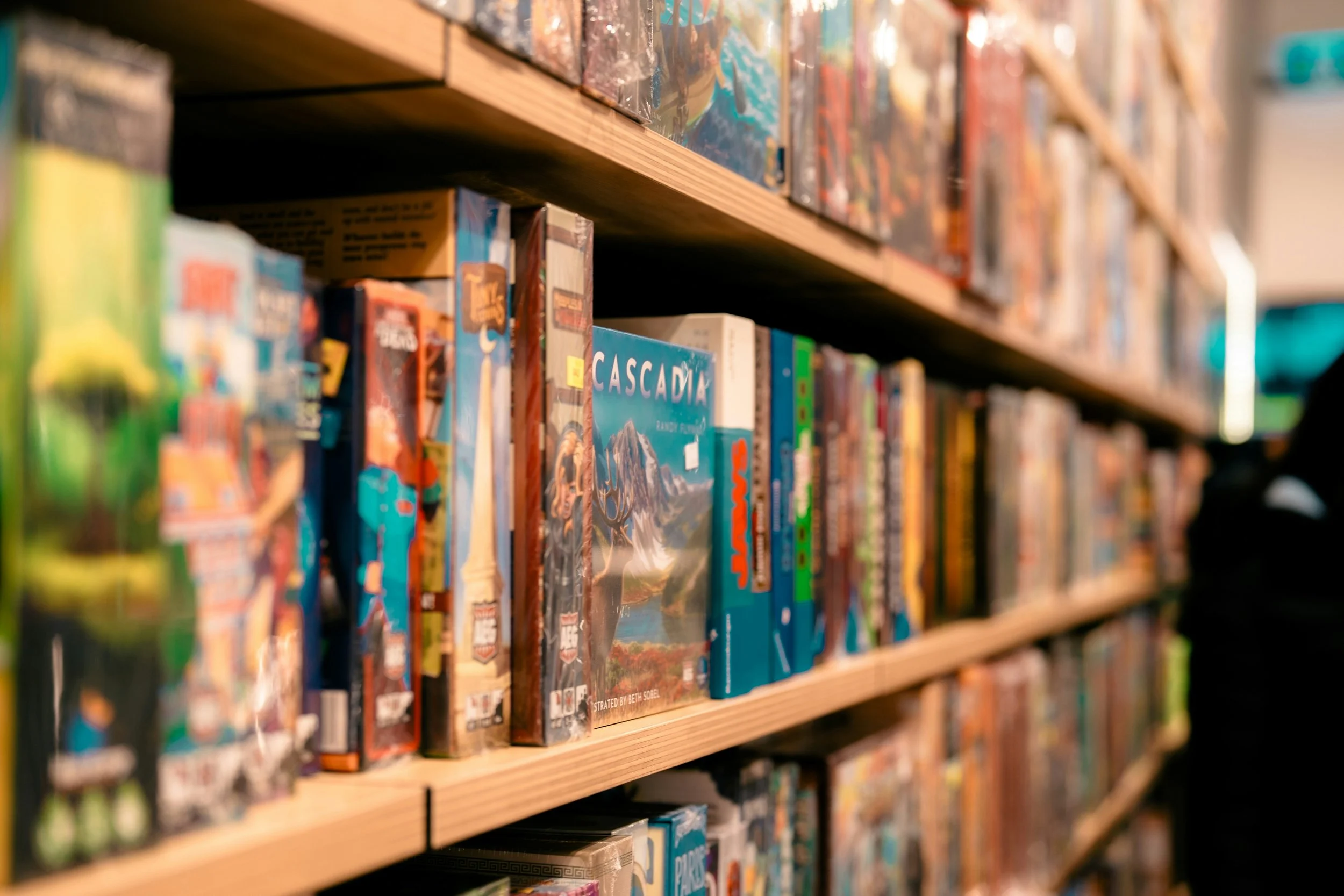 Shelves filled with various board games in a store.