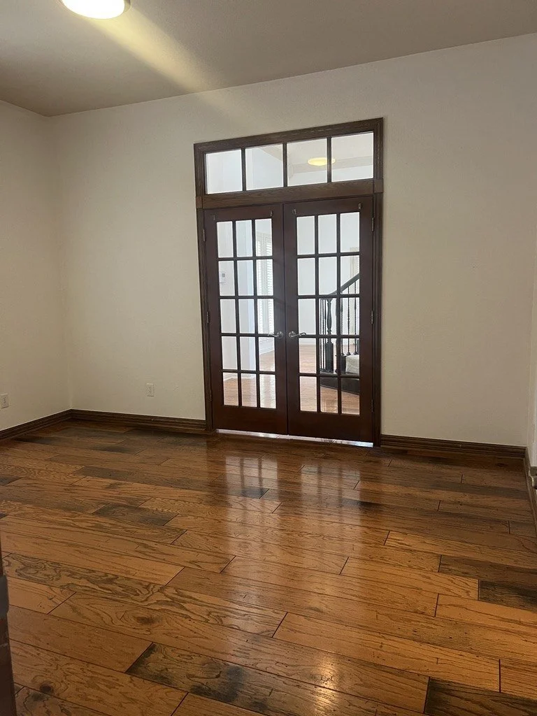 Hardwood floor in a room with French doors