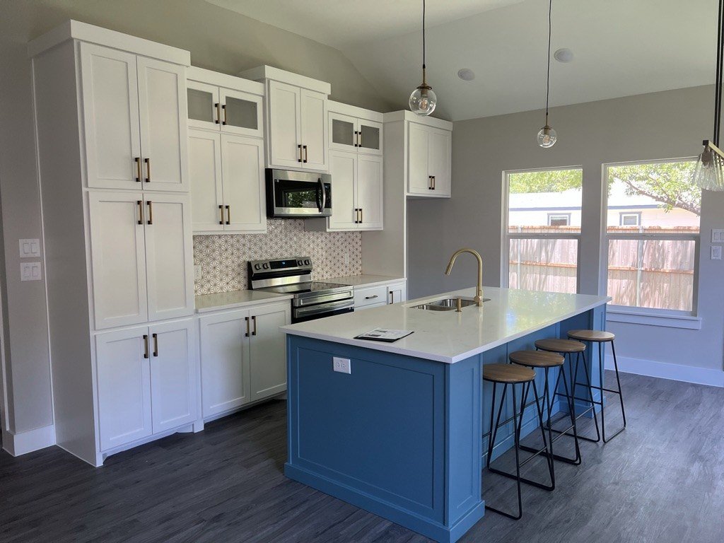 Custom white kitchen cabinets with a blue island