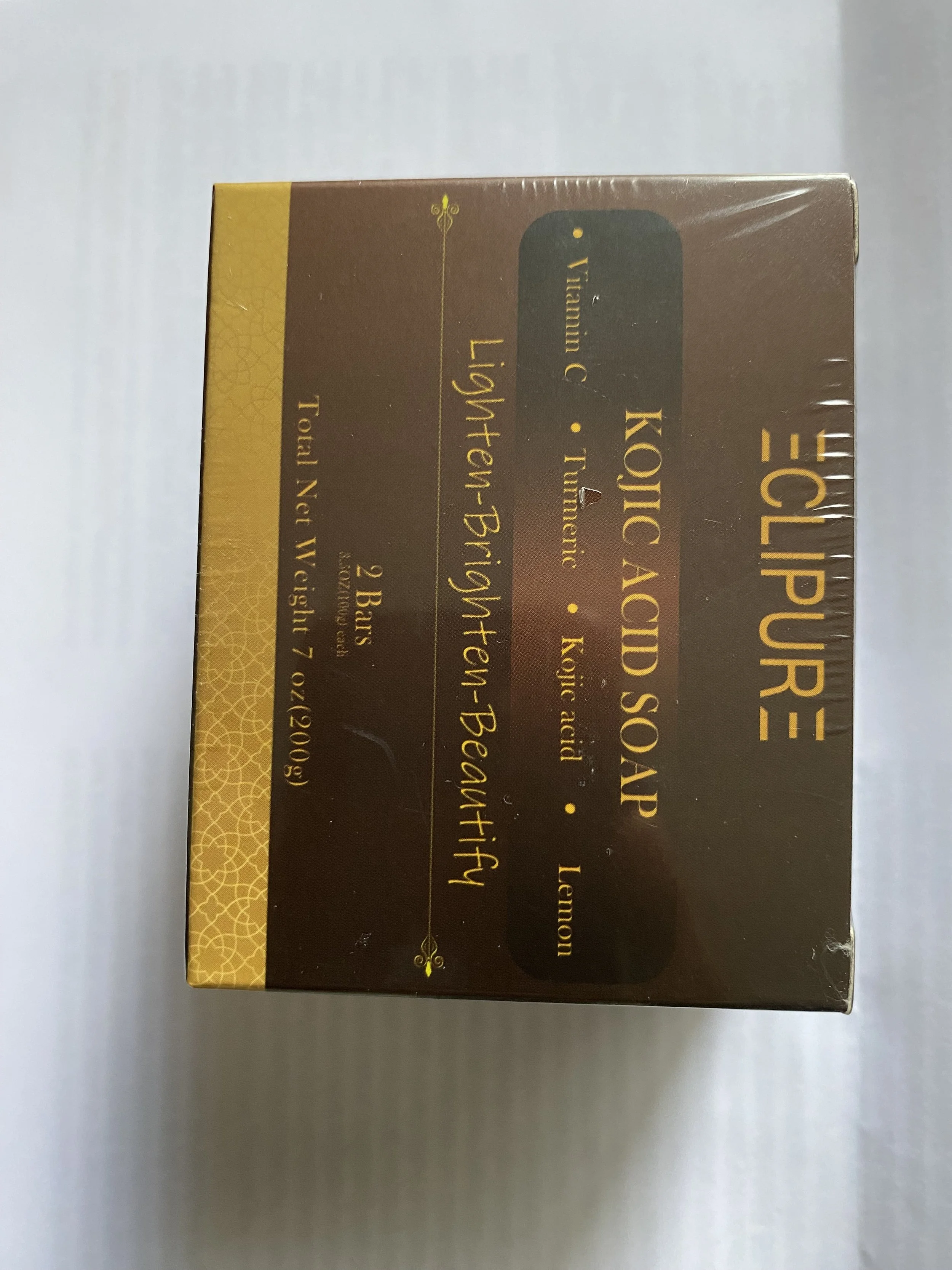 Box of Kojic Acid Soap with label in gold and brown colors, showing product name, ingredients, and weight details.