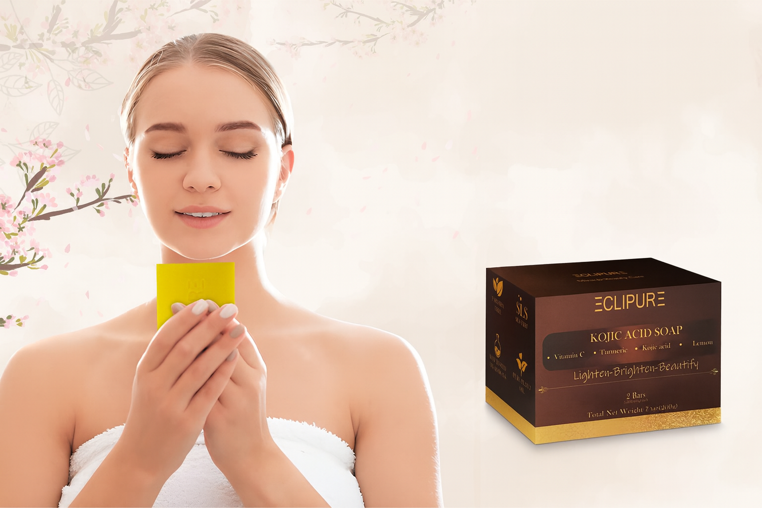 A woman with closed eyes and a slight smile holds a yellow soap dish close to her face, with a box of Eclipure Kojic Acid Soap on her right side, in front of a background with light-colored floral decorations.