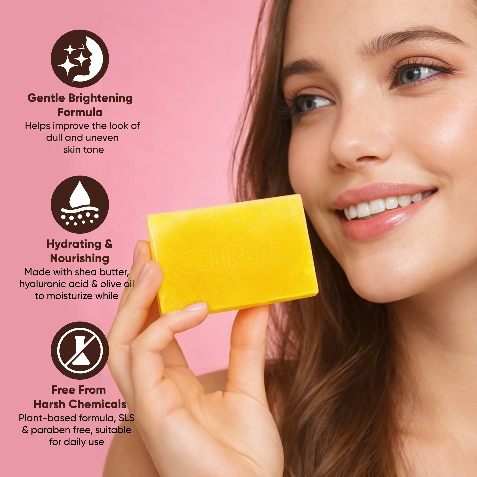 A woman with fair skin and long brown hair holding a yellow soap bar with a pink background. The soap has the word "ECLIPURE" embossed on it. Text overlays describe the soap's benefits: gentle brightening formula, hydrating and nourishing with shea butter, hyaluronic acid, and olive oil, and free from harsh chemicals like SLS and parabens.