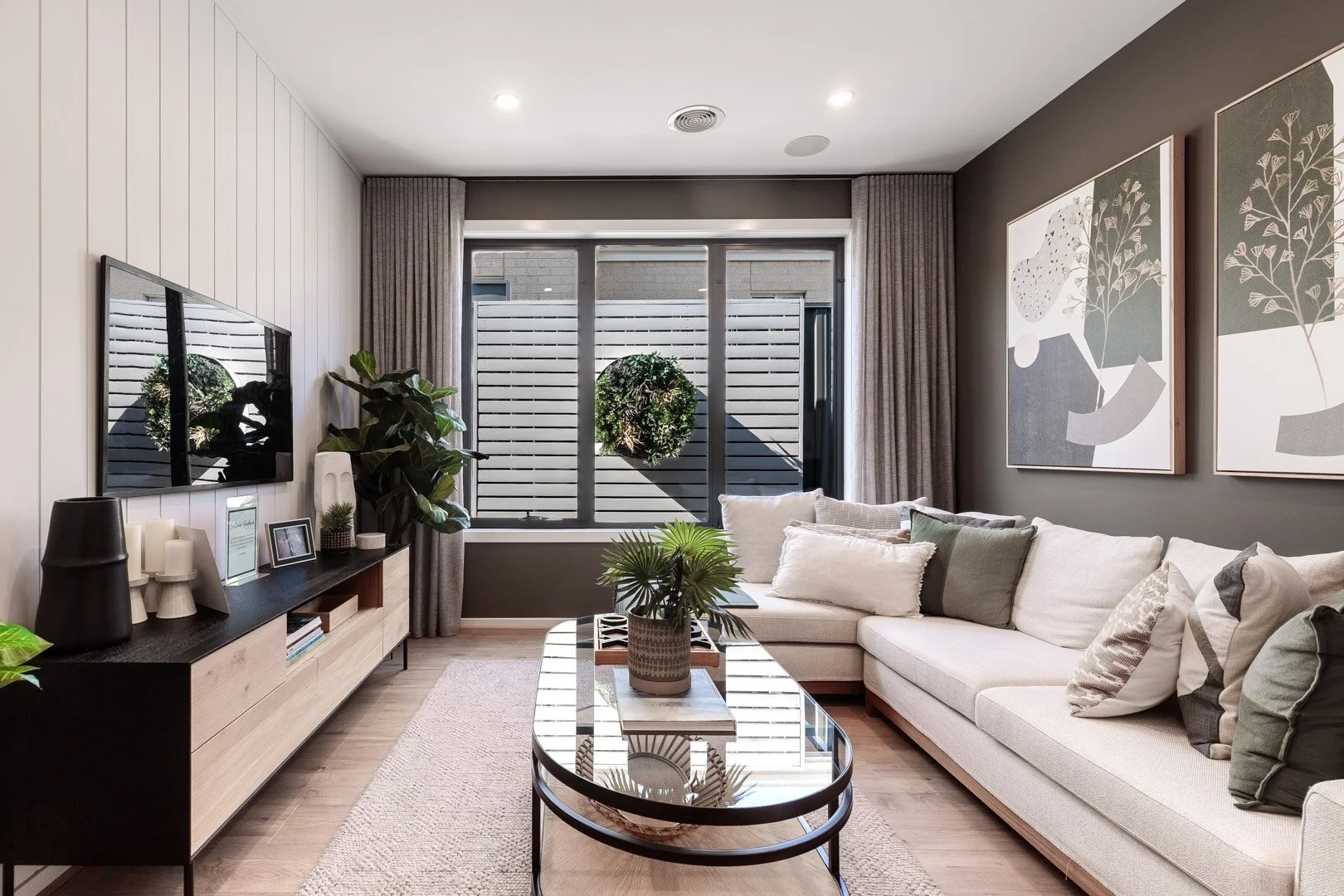 Standard suburban home at sunset with driveway and warm lighting