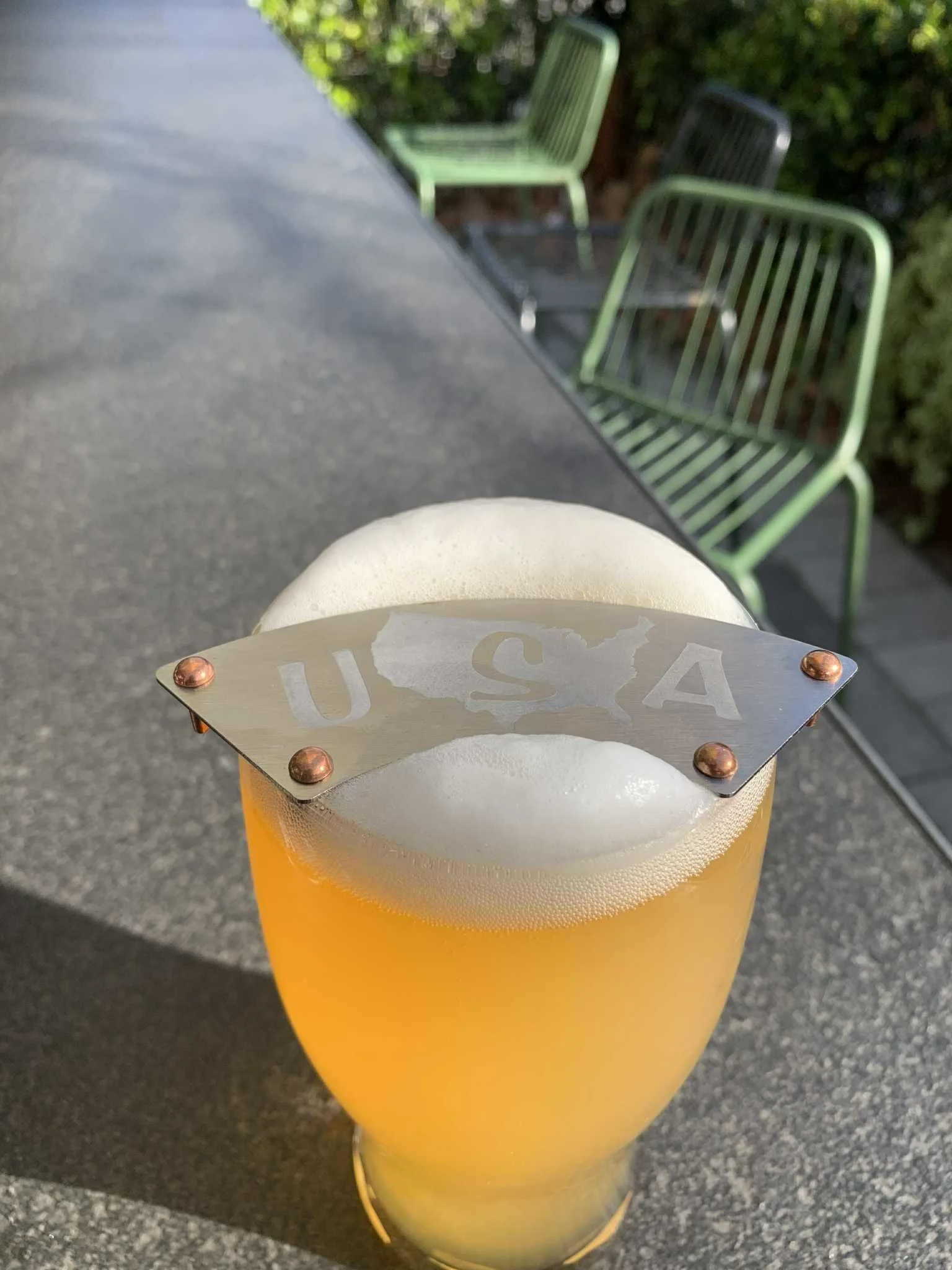 USA design Bush Ranger moustache guard sitting on a frothy glass of beer