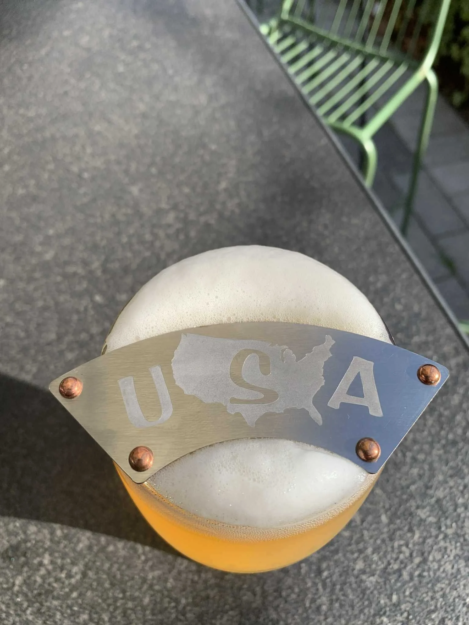 Bush Ranger moustache guard with USA design on a pint of beer in a beer garden
