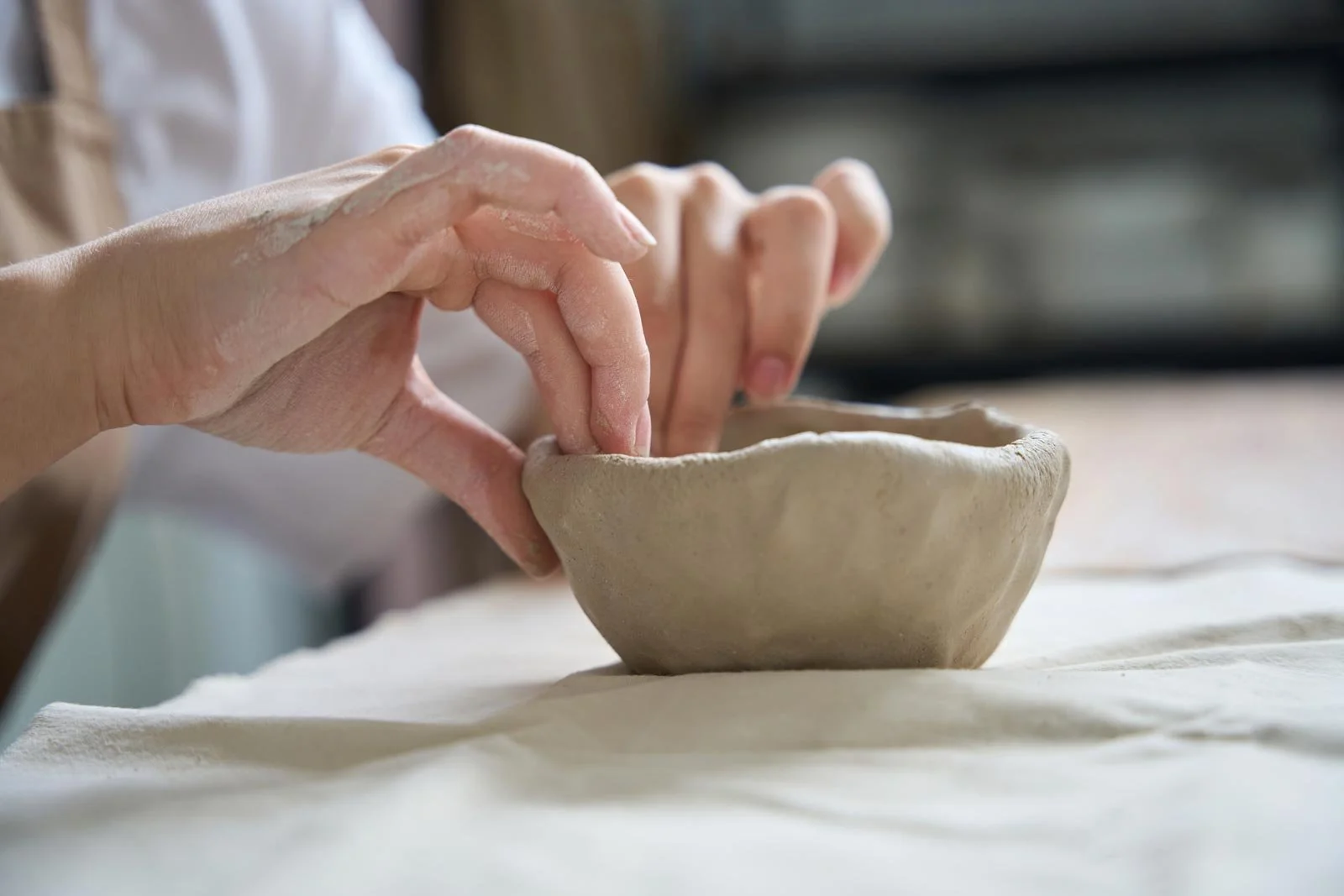 woman-at-her-desk-sculpting-a-clay-plate-2024-10-18-17-30-57-utc2.jpg