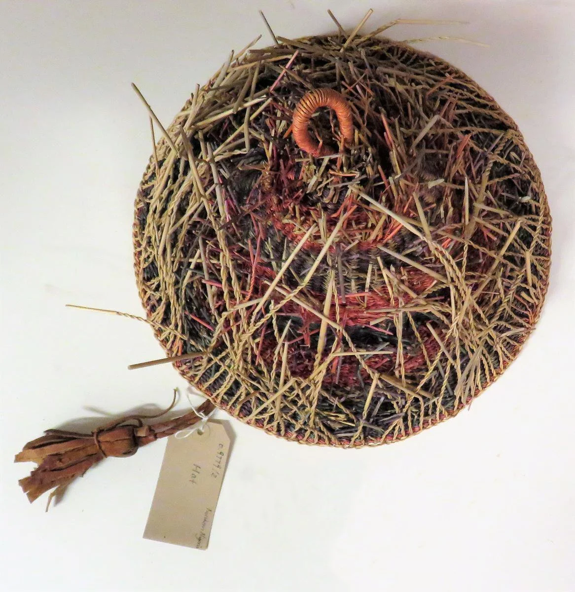 Hat made of alternating bands of dyed straw with projecting natural straw.