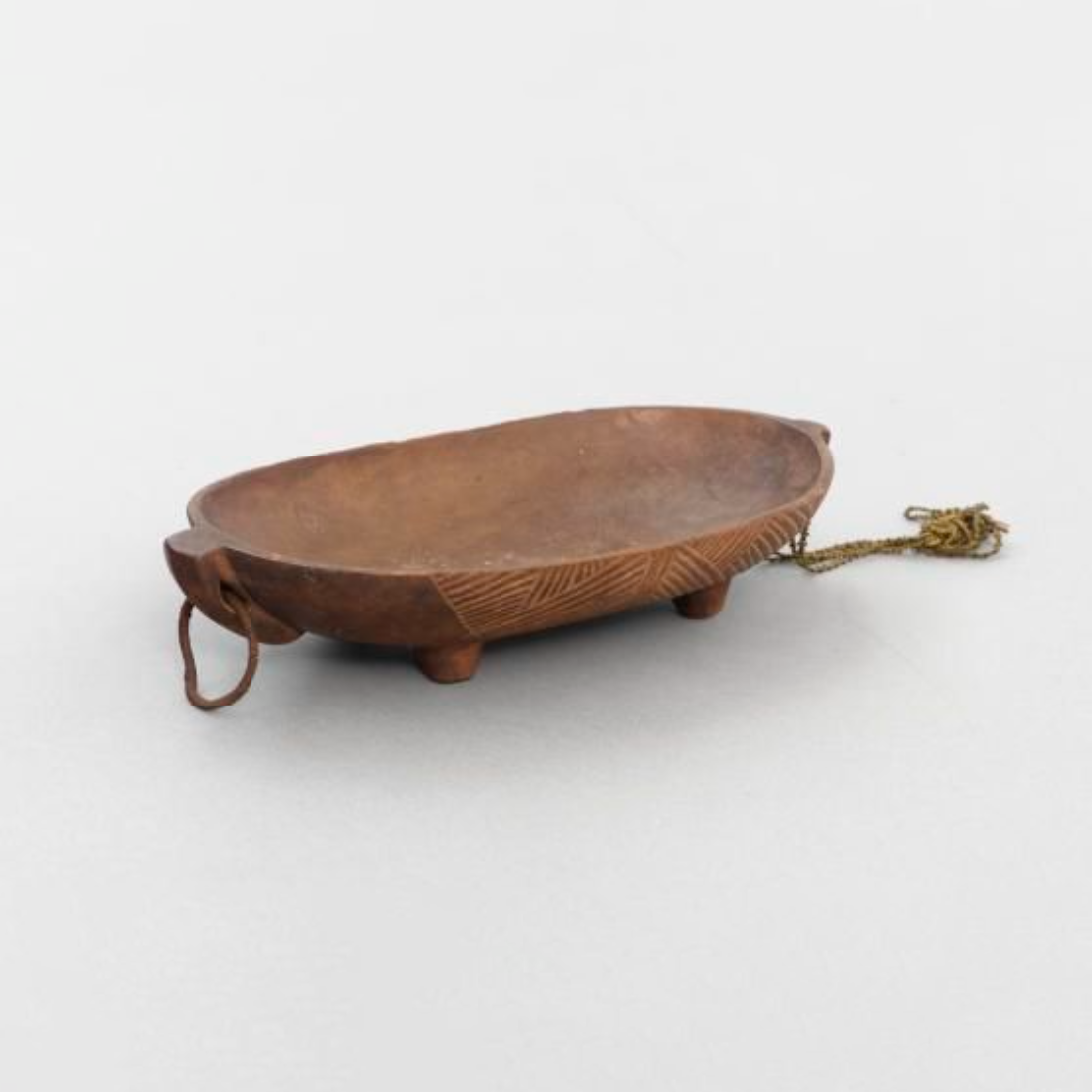Wooden oval dish on four legs with two handles.