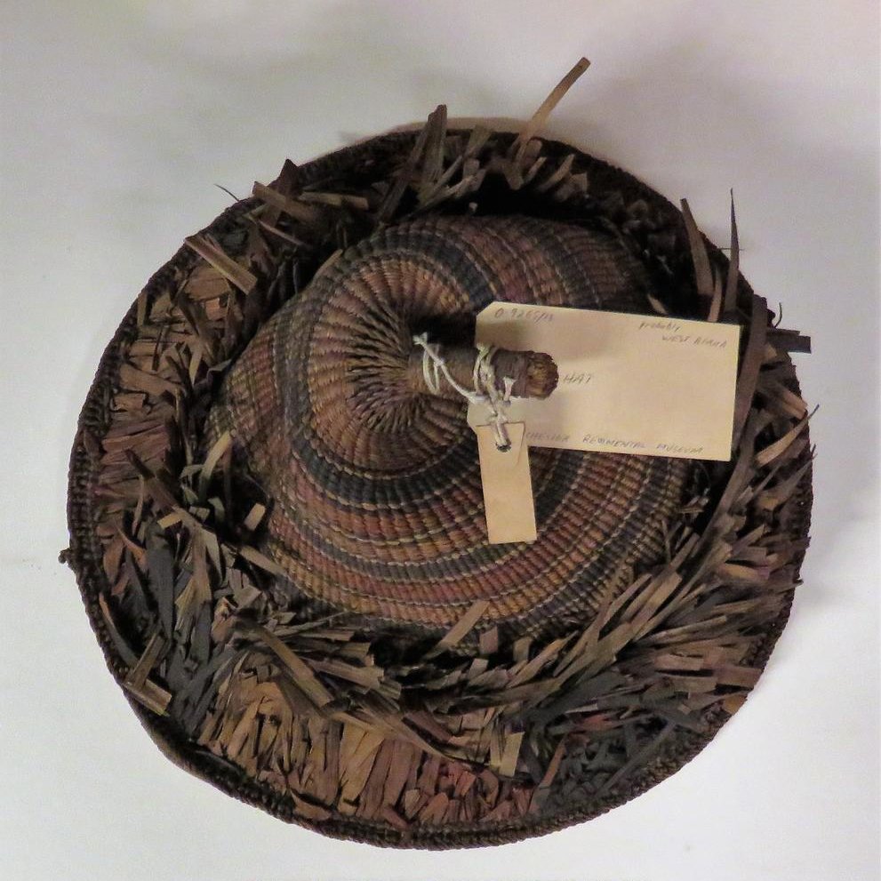 Hat that is conical in shape, with 'warp' ends gathered into a knob on top and wrapped with twisted leaves.