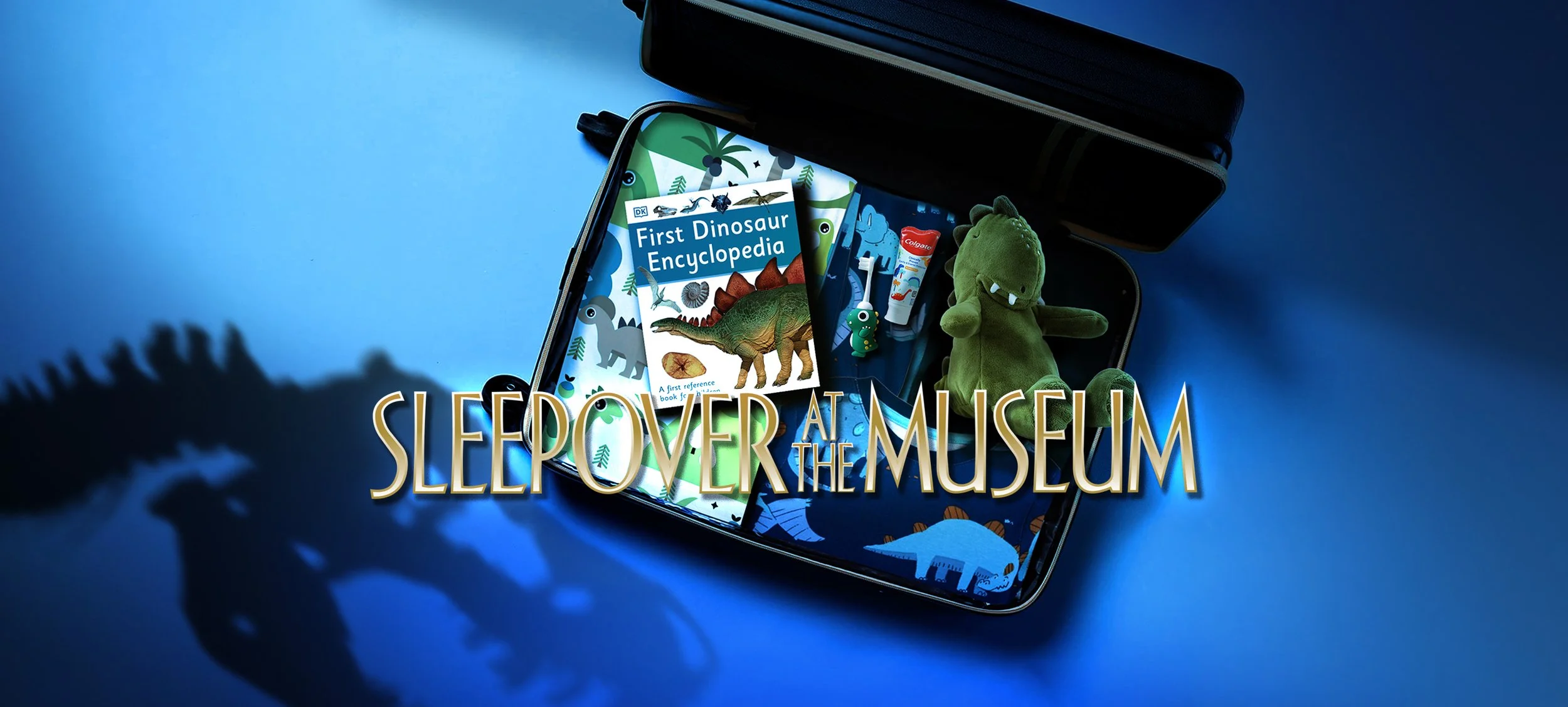 A suitcase full of dinosaur themed children's items, alongside a silhouette of a Tyrannosaurus rex skull. The words Sleepover at the Museum are overlaid on the image.