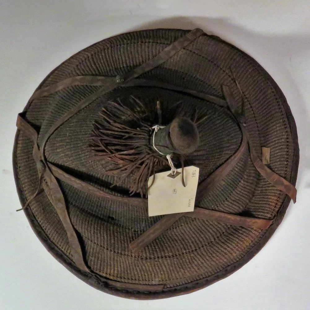 Hat made from woven grass or leaf strips and strengthened with circles of cane.