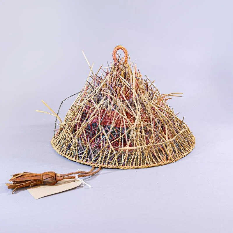 Hat made of alternating bands of dyed straw with projecting natural straw.