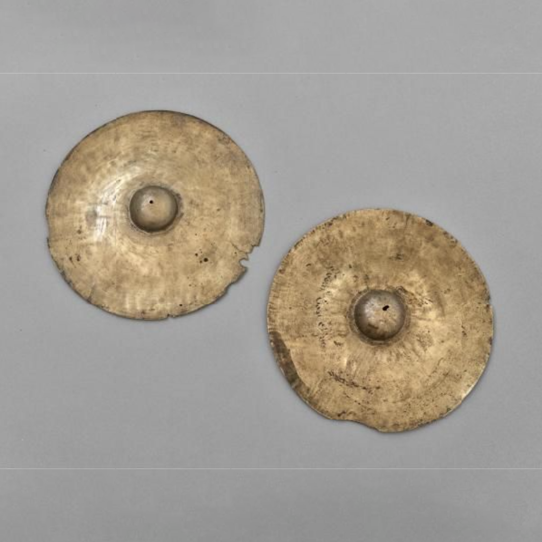 A pair of brass cymbals. They have been inscribed ‘From East Africa’.