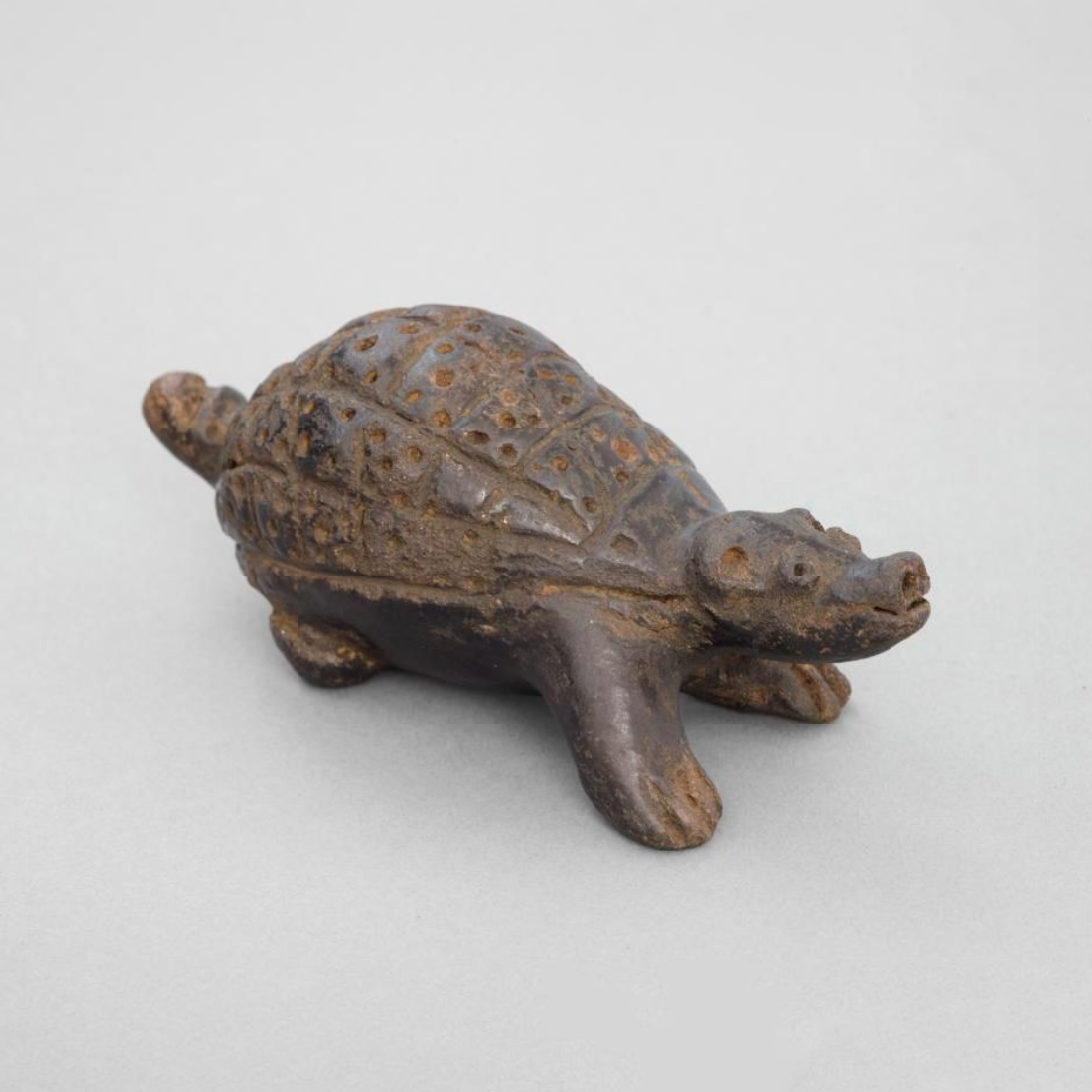 A pottery rattle in the form of an animal, possibly a tortoise.