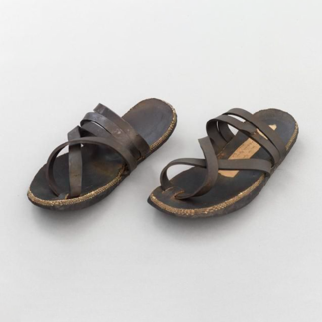 A pair of sandal made of the rubber from car tyres. They are a little worn.
