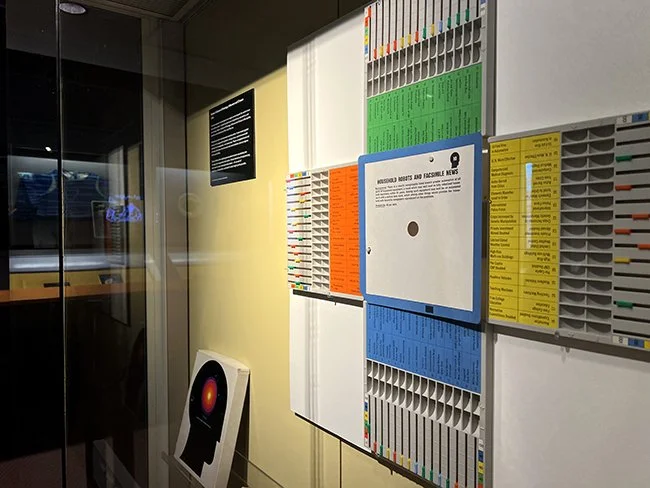 An colourful display within the exhibition Artefacts of Prediction in the Research Gallery at Manchester Museum.