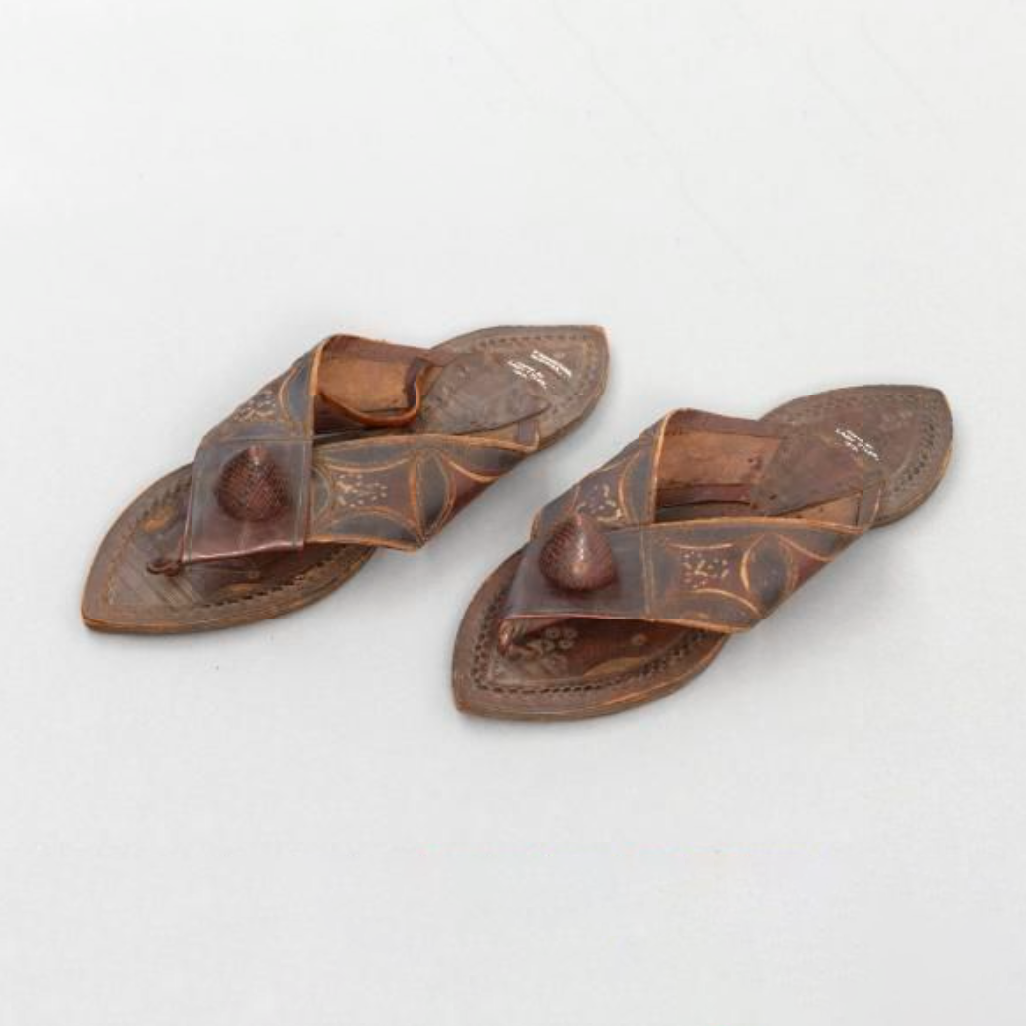 A pair of sandals. They have thin leather soles, hourglass in shape, sewn together.