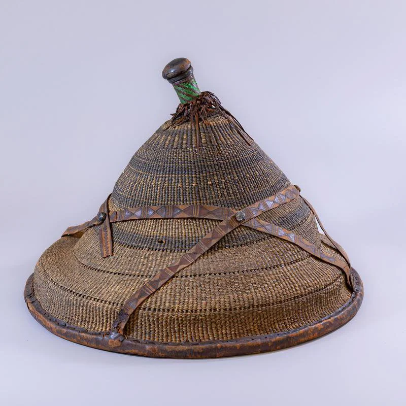 Hat made from woven grass or leaf strips and strengthened with circles of cane.