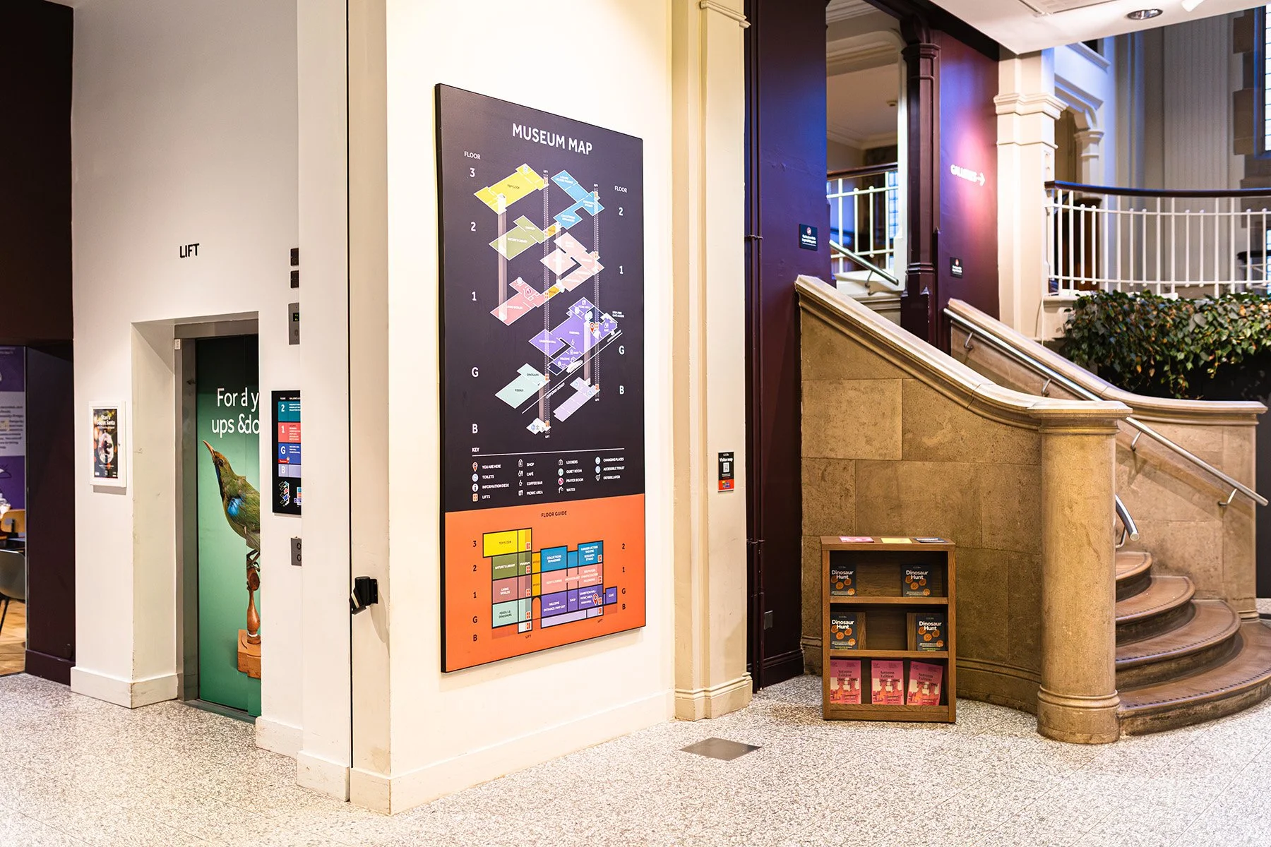 The Main Hall at Manchester Museum, showing the lift, main map and staircase.