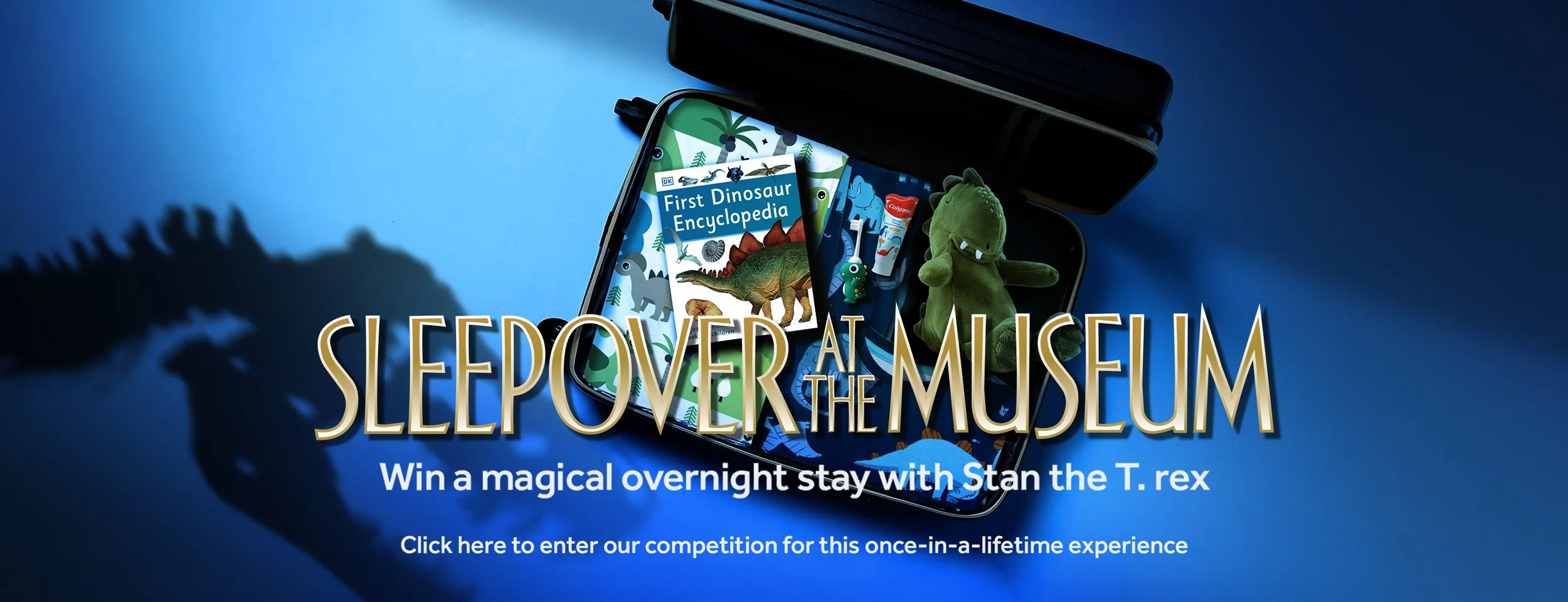 A suitcase full of dinosaur-themed children's items, next to the silhouette of a Tyrannosaurus rex, overlaid with the words Sleepover at the Museum.