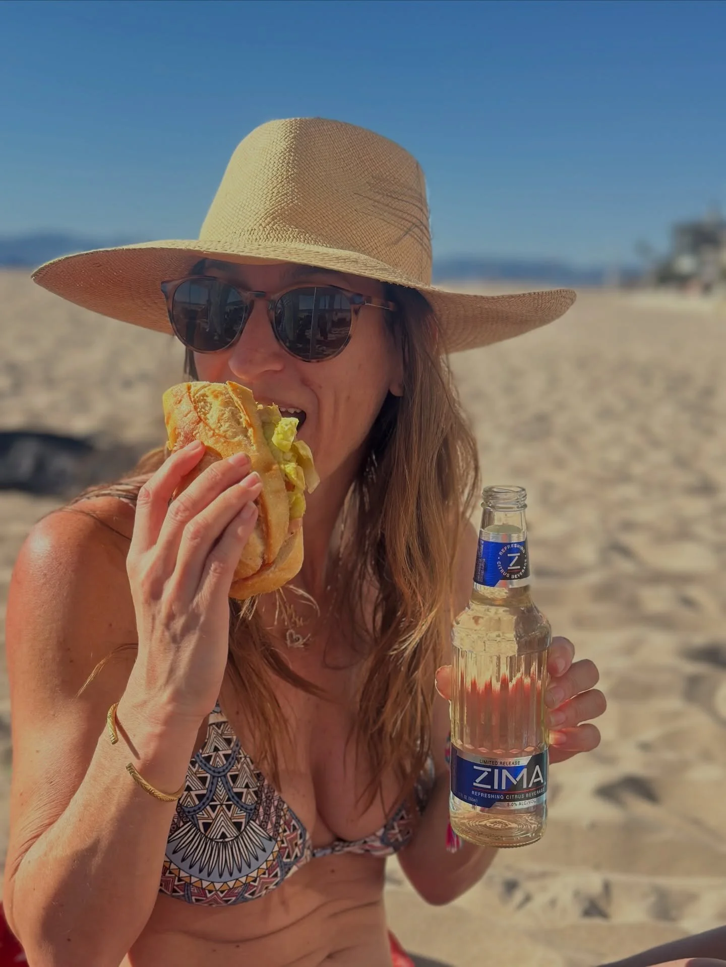 Took a bite out of an 80&deg; sunny day in March.
Italian sub from @boccatos_grocery in one hand, Zima in the other.
Adding some sunshine to your feed&hellip; la dolce vita, 90s style. ☀️

What&rsquo;s your go-to beach snack? Who&rsquo;s with me? 🌊?