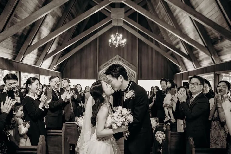 A couple getting married at Chapel on the Hill in the quaint chapel made out of redwood in the Santa Cruz Mountains