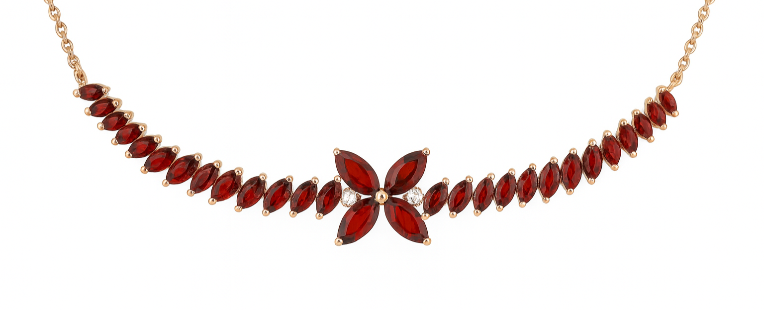 Gold necklace with marquise-cut red gemstones and a flower-shaped cluster of red gemstones in the center, accented with small clear stones.