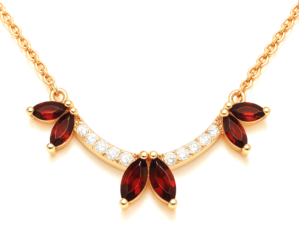 Gold necklace with red gemstone flower accents and diamond detail.