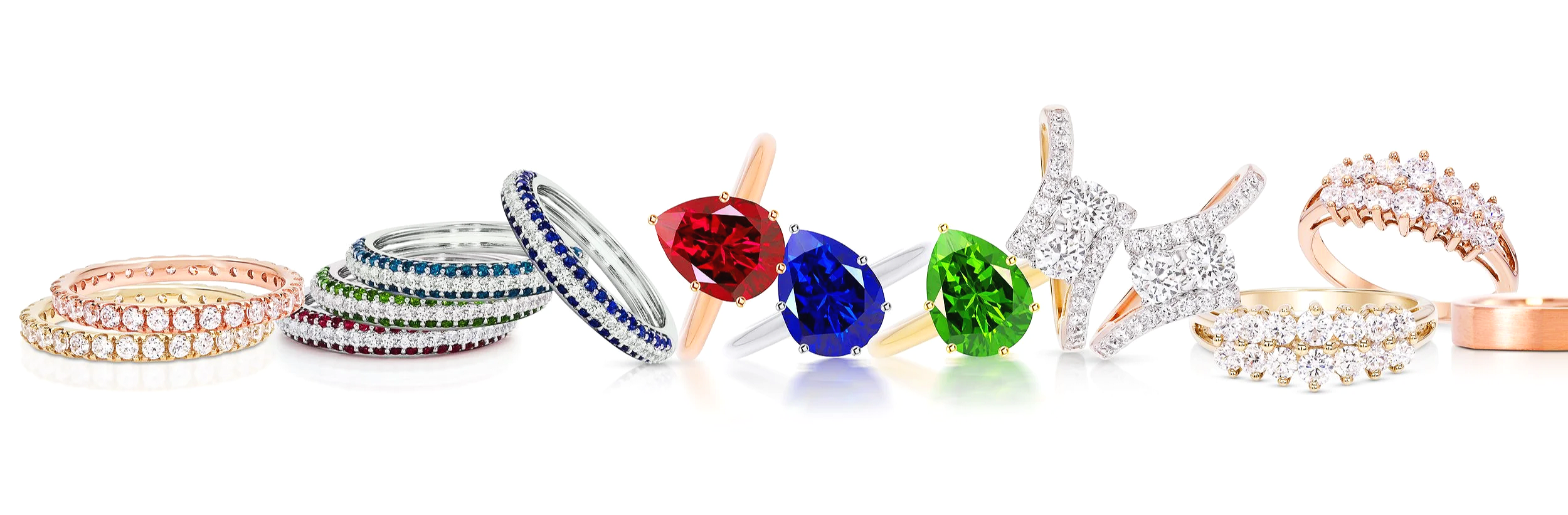 A selection of colorful diamond rings arranged in a row, featuring various styles and colors including rose gold, silver, and gold bands with diamonds and gemstones.