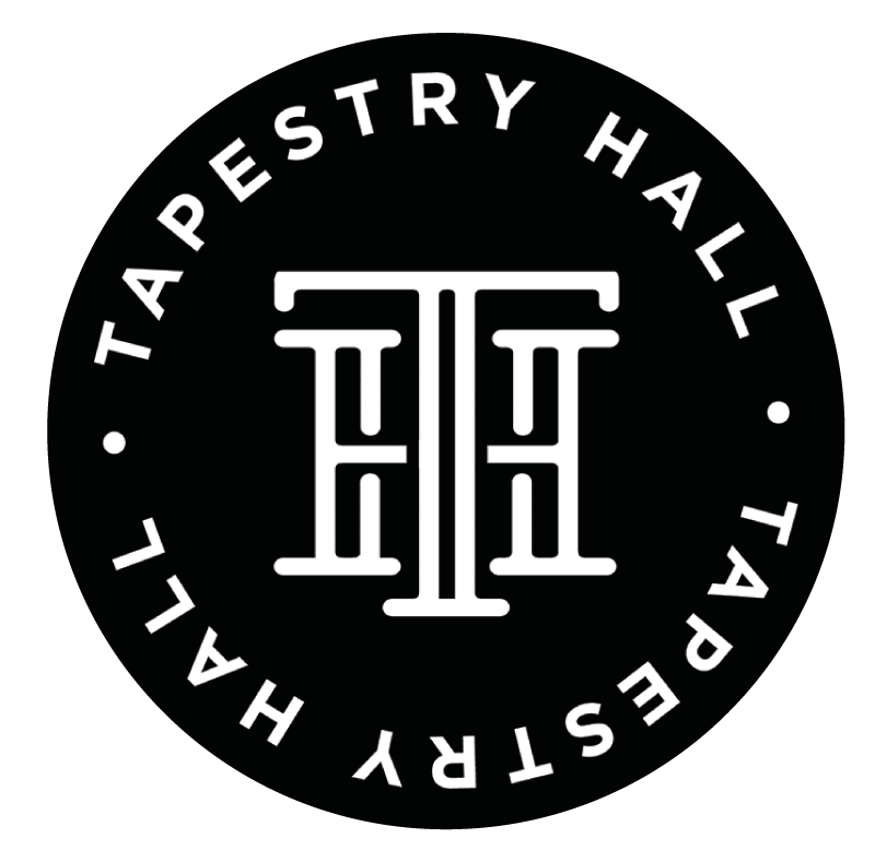 A black circular logo with white text reading 'Tapestry Hall' around it and a stylized monogram in the center combining the letters T and H.