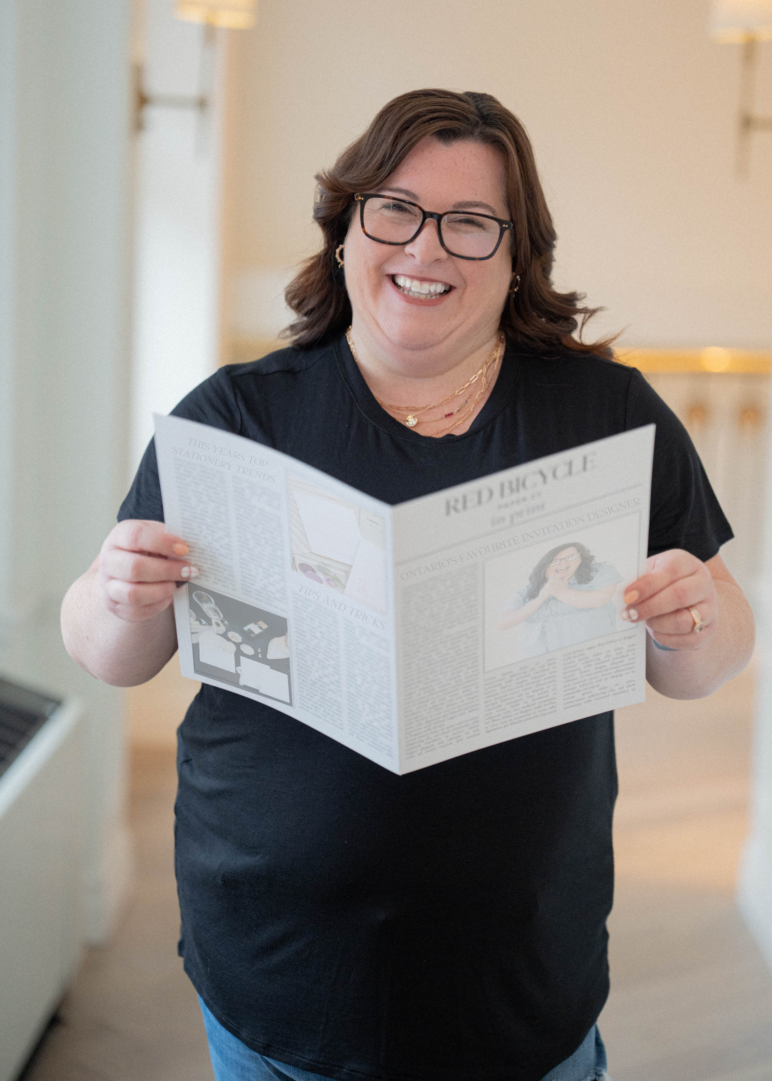 Wedding stationer reading a stationery newspaper