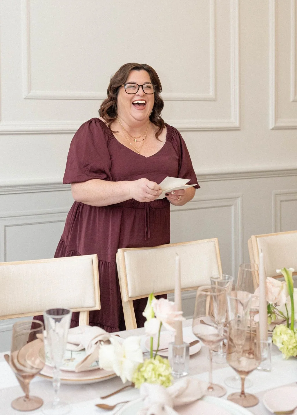 Stationery designer holding a menu at a wedding venue