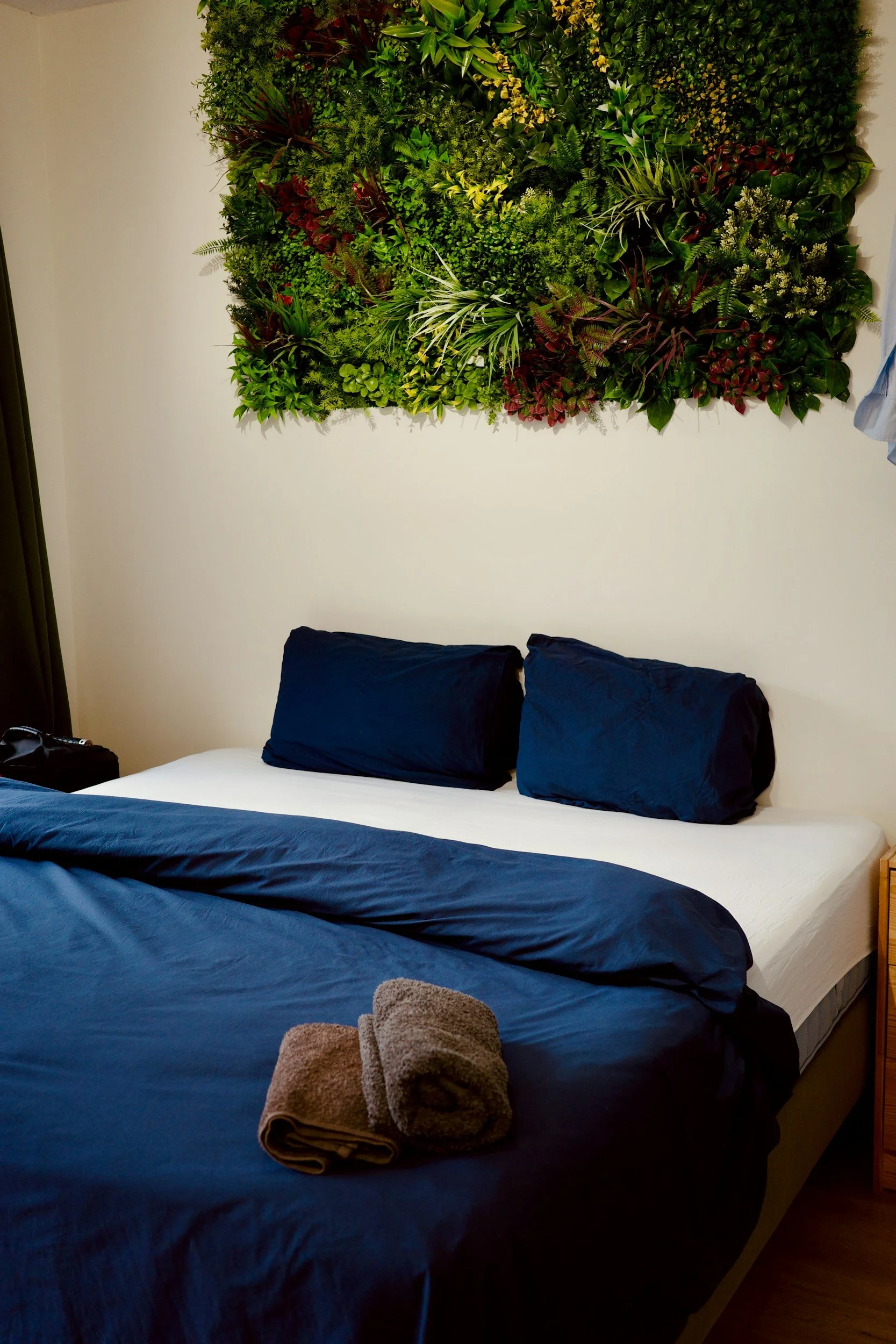 Welcoming guest bedroom with neatly folded towels and organized bedding in a St. Louis home